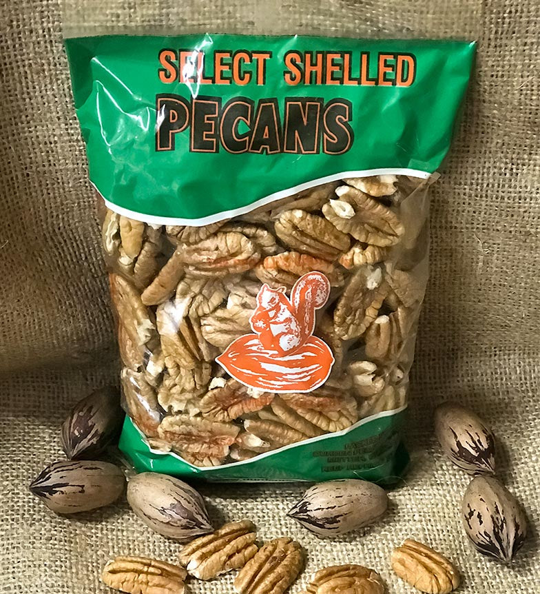 One-pound bag of shelled pecan halves displayed upright on a burlap background