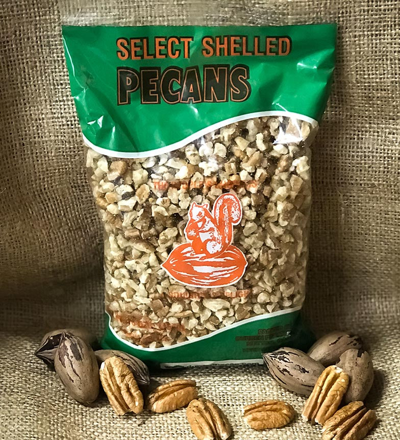 One-pound bag of shelled pecan pieces displayed upright on a burlap background